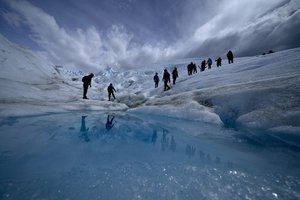 Tourists walk on the Perito Moreno Glacier at Los Glaciares National Park, near El Calafate, Argentina, Tuesday, Nov. 2, 2021.