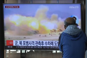 A TV screen shows a file image of North Korea's military exercise during a news program at the Seoul Railway Station in Seoul, South Korea, Wednesday, Oct. 19, 2022.