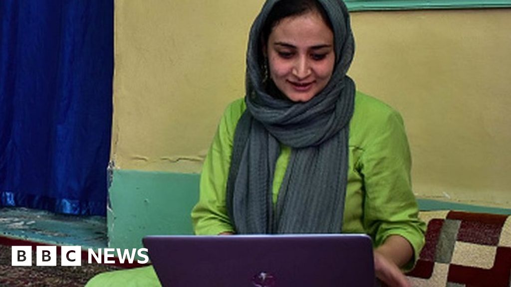 Kashmiri woman photojournalist Sanna Irshad Mattoo looking at her laptop at her residence in Srinagar