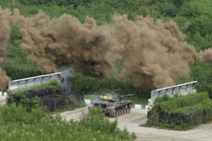 A Taiwanese tank is covered by smoke grenade during a military exercise in Hengchun, Pingtung county in southern Taiwan on Wednesday, Sept. 7, 2022