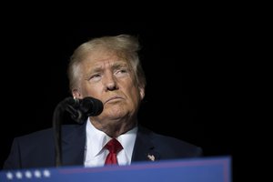 FILE - Former President Donald Trump pauses while speaking at a rally at the Minden Tahoe Airport in Minden, Nev., on Oct. 8, 2022.