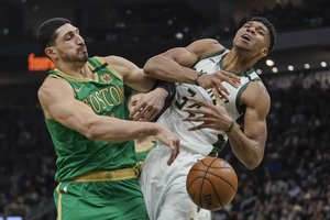 Enes Kanter fouls Giannis Antetokounmpo during the first half of an NBA basketball game Thursday, Jan. 16, 2020, in Milwaukee