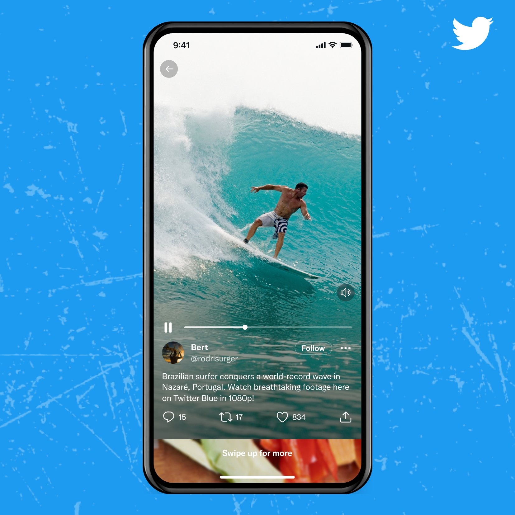 A mobile device against a blue background with a Twitter logo in the upper right corner. The device shows a video of a surfer in the new immersive video player spanning the entire screen. A label reads, "Swipe up for more? at the bottom of the screen, showing a partial screen preview of the next video.