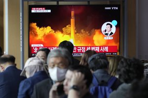 A TV screen shows a file image of North Korea's missile launch during a news program at the Seoul Railway Station in Seoul, South Korea, Friday, Oct. 14, 2022