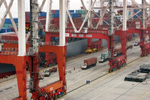 Container gantry detail and loading of a ship in the deep water port of Yangshan, Shanghai, China