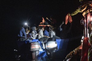 Rescuers approach a migrants' boat adrift in international waters off Malta in the Mediterranean Sea, Tuesday, Oct. 25, 2022