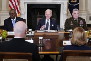 President Joe Biden meets with military leaders, including Defense Secretary Lloyd Austin, left, and Chairman of the Joint Chiefs of Staff Gen. Mark Milley, in the State Dining Room of the White House in Washington, Wednesday, Oct. 26, 2022.