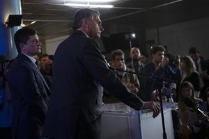 Brazilian President Jair Bolsonaro, second left, who is running for a second term, right, stands next to his former Justice Minister Sergio Moro at a press conference after a presidential debate in Rio de Janeiro, Brazil, Saturday, Oct. 29, 2022