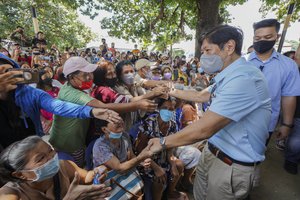 Philippine President Ferdinand Marcos Jr., greets residents during his visit a day after a strong quake struck Bangued, Abra province, northern Philippines on Thursday, July 28, 2022