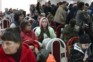 Evacuees from Kherson gather upon their arrival at the railway station in Anapa, southern Russia, Tuesday, Oct. 25, 2022. Russian authorities have encouraged residents of Kherson to evacuate, warning that the city may come under massive Ukrainian shelling.