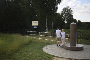 People visit the area of tripoint marking the place where borders of Poland, Lithuania and Russia's Kaliningrad Oblast meet, in Zerdziny, Poland, July 7, 2022