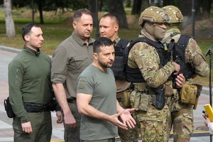 Ukrainian President Volodymyr Zelenskyy, center, reacts after his press conference in Kyiv, Ukraine, Friday, Sept. 9, 2022.