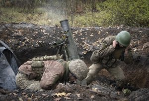 Ukrainian soldiers fire a mortar in the front line near Bakhmut, in the Donetsk region, Ukraine, Thursday, Oct. 27, 2022.