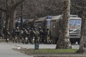 FILE - Russian army soldiers stand next to their trucks during a rally against Russian occupation in Svobody (Freedom) Square in Kherson, Ukraine, Monday, March 7, 2022.