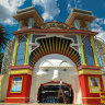 Artist Mark Ogge paints key features of Mr Moon’s face at Luna Park ahead of 110th celebrations in December. 