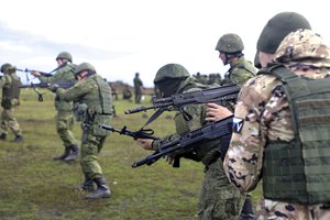 Recruits hold their weapons during a military training at a firing range in Donetsk People's Republic controlled by Russia-backed separatists, eastern Ukraine, Tuesday, Oct. 4, 2022.