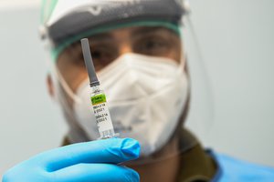 A military doctor administers influenza vaccine in Milan, Italy on 11 December 2020