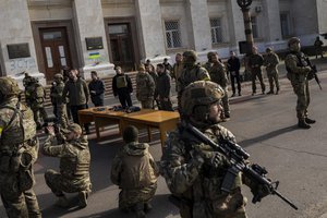 Ukrainian President Volodymyr Zelensky guarded by soldiers, gives a speech in Kherson, southern Ukraine, Monday, Nov. 14, 2022. Ukraine's retaking of Kherson was a significant setback for the Kremlin and it came some six weeks after Russian President Vladimir Putin annexed the Kherson region and three other provinces in southern and eastern Ukraine — in breach of international law — and declared them Russian territory.