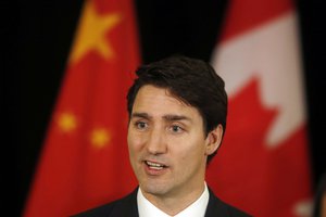 In this Dec. 5, 2017, photo, Canadian Prime Minister Justin Trudeau speaks to the media at a hotel in Beijing, China.