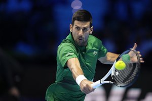 Serbia's Novak Djokovic returns the ball to Greece's Stefanos Tsitsipas during their singles tennis match of the ATP World Tour Finals, at the Pala Alpitour in Turin, Italy, Monday, Nov. 14, 2022