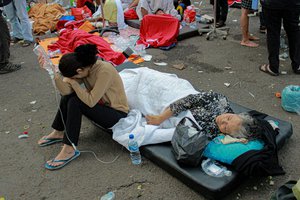 Earthquake survivors are treated outside of a hospital in Cianjur, West Java, Indonesia, Monday, Nov. 21, 2022