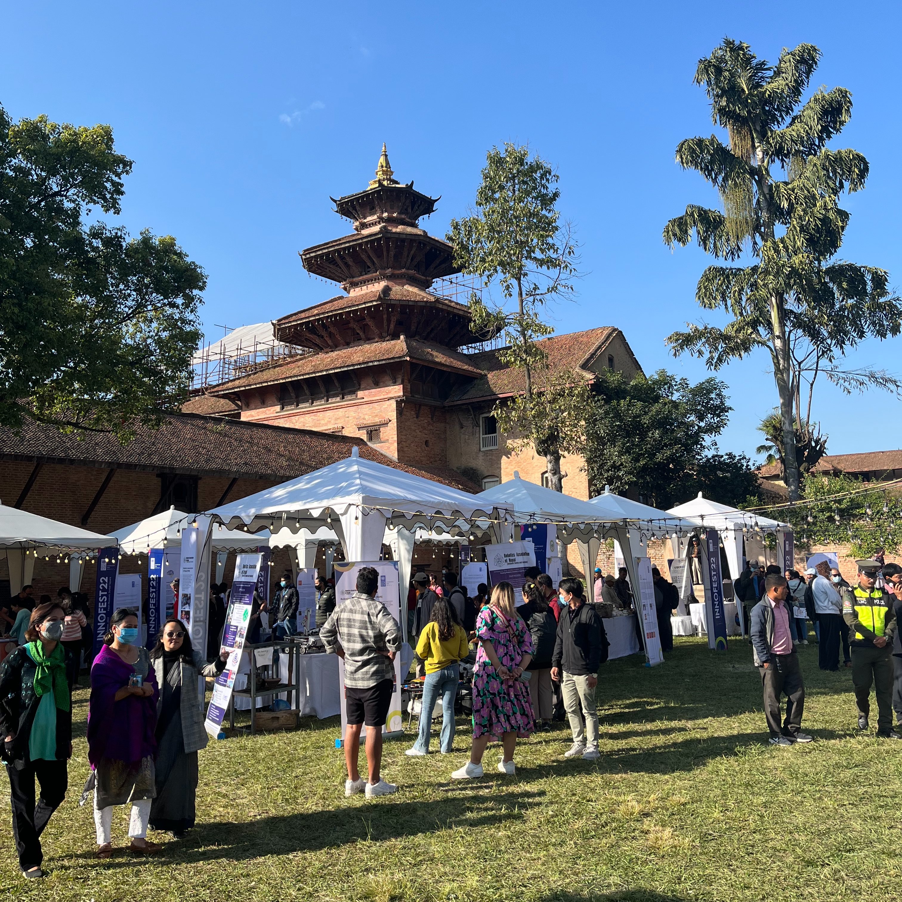 people in a fest with temple in background