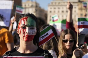 People stage a protest against the death of Mahsa Amini, a woman who died while in police custody in Iran, during a rally in central Rome, Saturday, Oct. 29, 2022