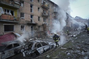 Ukrainian State Emergency Service firefighters work to extinguish a fire at the scene of a Russian shelling in the town of Vyshgorod outside the capital Kyiv, Ukraine, Wednesday, Nov. 23, 2022.