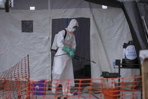 File - A medical worker disinfects a tent used for suspected Ebola victims inside the Ebola isolation center of Madudu Health Center III, in the village of Madudu, in the Mubende district of Uganda Tuesday, Nov. 1, 2022. The head of the World Health Organization said Wednesday, Nov 16., 2022, that he expects the first doses of Ebola vaccine targeting the strain causing the current outbreak in Uganda to arrive in the country next week.