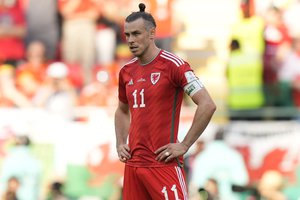 Wales' Gareth Bale reacts after Iran's Ramin Rezaeian scored his side's second goal during the World Cup group B soccer match between Wales and Iran, at the Ahmad Bin Ali Stadium in Al Rayyan , Qatar, Friday, Nov. 25, 2022