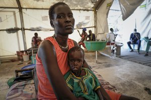 Nyayiar Kuol holds her severely malnourished 1-year-old daughter Chuoder Wal in a hospital run by Medicines Sans Frontieres (Doctors Without Borders) in Old Fangak in Jonglei state, South Sudan Tuesday, Dec. 28, 2021. Aid groups say more people than ever in the country will face hunger this year, because of the worst floods in 60 years as well as conflict and the sluggish implementation of the peace agreement that has denied much of the country basic services.