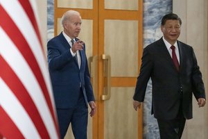 U.S. President Joe Biden, left, arrives with Chinese President Xi Jinping for a meeting on the sidelines of the G20 summit meeting, Monday, Nov. 14, 2022, in Bali, Indonesia.