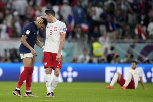 Kylian Mbappe and obert Lewandowski speak after the World Cup round of 16 soccer match between France and Poland