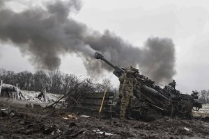 Ukrainian servicemen shoot towards Russian positions in the frontline at an undisclosed location in the Donetsk region, Ukraine, Wednesday, Nov. 23, 2022