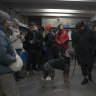 People rest in the subway station being used as a bomb shelter during a rocket attack in Kyiv on Monday.