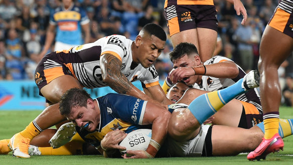 Jarrod Wallace scores for the Titans against the Broncos at Cbus Super Stadium in their round 2 match in 2021.