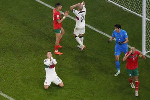 Cristiano Ronaldo, left, reacts after he failed to score, as Morocco's goalkeeper Yassine Bounou, right, celebrates