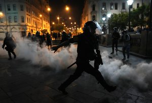 Tear gas is returned to police trying to break up supporters of ousted President Pedro Castillo at plaza San Martin in Lima, Peru, Sunday, Dec. 11, 2022