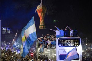 Players of the Argentine soccer team that won the World Cup arrive to the training grounds where they will spend the night after landing at Ezeiza airport on the outskirts of Buenos Aires, Argentina, Tuesday, Dec. 20, 2022