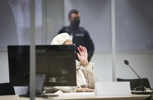 Irmgard Furchner, accused of being part of the apparatus that helped the Nazis' Stutthof concentration camp function, arrives at the court for the verdict in her trial in Itzehoe, Germay, Tuesday, Dec. 20, 2022