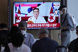 People watch a TV showing an image of North Korea leader Kim Jong Un, during a news program at the Seoul Railway Station in Seoul, South Korea, Thursday, July 28, 2022