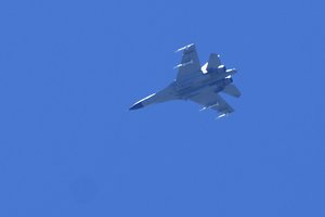 A fighter jet flies in the direction of Taiwan seen from the 68-nautical-mile scenic spot, the closest point in mainland China to the island of Taiwan, in Pingtan in southeastern China's Fujian Province, Friday, Aug. 5, 2022