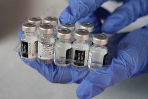 A medical worker shows vials of the Pfizer COVID-19 vaccine during a vaccination campaign at the Patriot Candrabhaga Stadium in Bekasi on the outskirts of Jakarta, Indonesia. Tuesday, Feb. 8, 2022