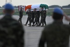 Irish U.N. peacekeepers, carry the coffin draped by their country flag of their comrade Pvt. Seán Rooney who was killed during a confrontation with residents near the southern town of Al-Aqbiya on Wednesday night, during his memorial procession at the Lebanese army airbase, at Beirut airport, Sunday, Dec. 18, 2022.