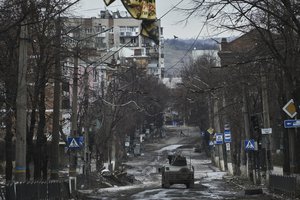 Ukrainian soldiers ride in a Humvee in Bakhmut, Donetsk region, Ukraine, Wednesday, Dec. 21, 2022.