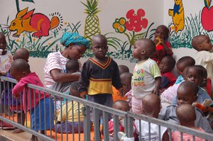 During afternoon playtime, the 49 babies compete for toys, to held by volunteers, space and fresh air, Kampala, Uganda