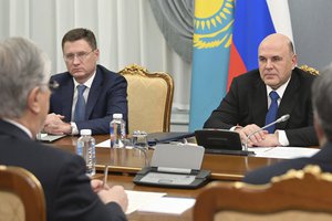 Russian Prime Minister Mikhail Mishustin, right, listens to Kazakhstan's President Kassym-Jomart Tokayev, left back to the camera, as Deputy Prime Minister Alexander Novak, left, attends the talks in Moscow, Russia, Monday, Nov. 28, 2022.