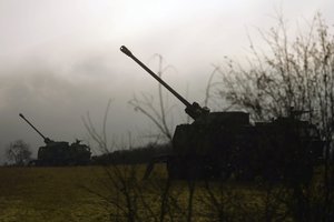 In this photo provided by the Serbian Defense Ministry Press Service, Serbian army self-propelled 155 mm gun-howitzers are seen on position near administrative line with Kosovo, south Serbia, Monday, Dec. 26, 2022.