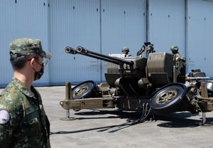 Taiwanese soldiers operate a Oerlikon 35mm twin cannon anti-aircraft gun at a base in Taiwan's southeastern Hualien county on Thursday, Aug. 18, 2022