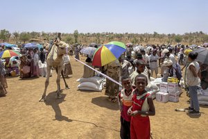 File - Children stand at a food distribution site in the town of Adi Mehameday, in the western Tigray region of Ethiopia, Saturday, May 28, 2022. Hunger is tightening its grip on millions of people in Ethiopia who are facing a combination of conflict in the north and drought in the south while dwindling resources mean food and nutrition support may run dry from next month, the World Food Programme (WFP) warned Thursday, June 23, 2022.